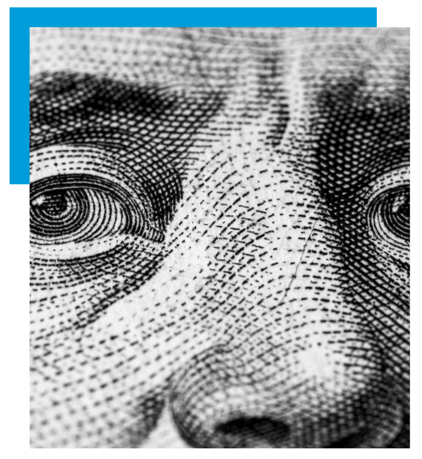 Zoomed-in image of Benjamin Franklin’s eyes from a U.S. dollar bill, symbolizing scrutiny and financial insight.