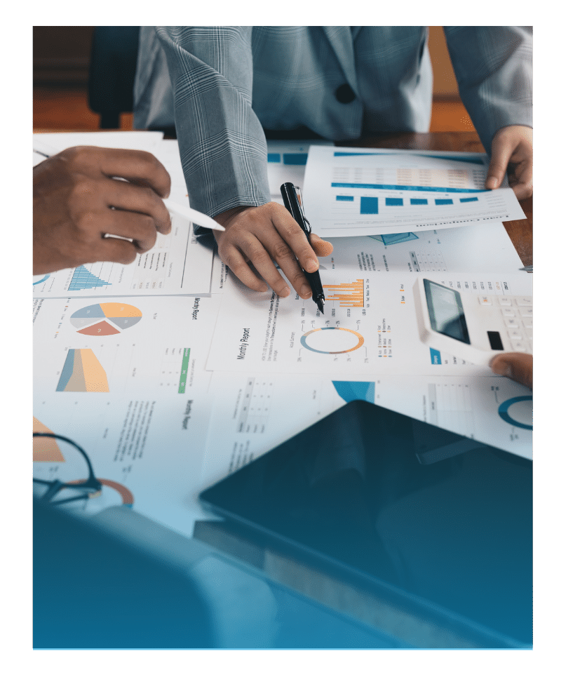 Hands of a business team reviewing printed financial data and pie charts during a planning session